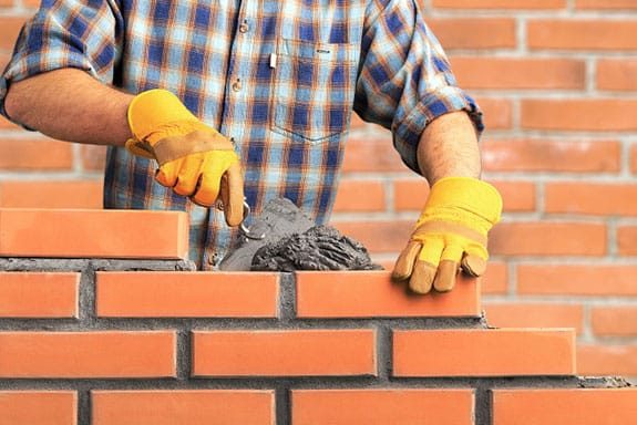 Worker Installing Brick Masonry — GRT Building Supplies in Port Stephens, NSW